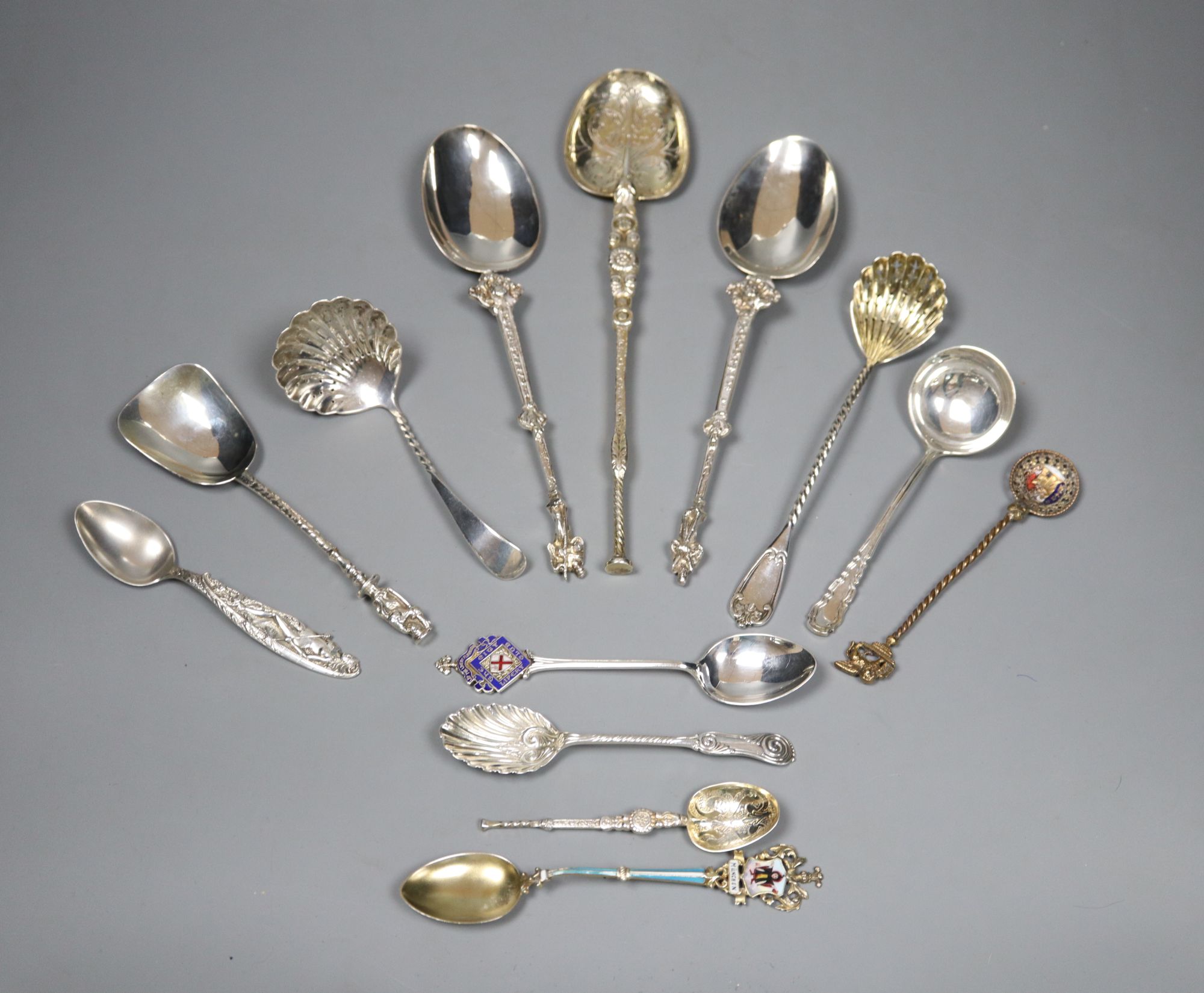 An ornate Edwardian silver gilt spoon, 22cm, ten other assorted silver spoons including continental and silver and two small